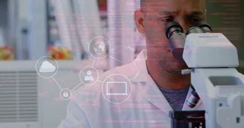 Lab tech leaning into microscope as cloud icons appearing forming network Stock Footage 330444419
