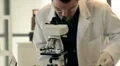 lab tech looking through microscope HD Footage