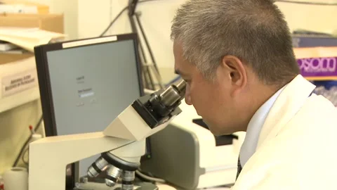 Lab Tech on Microscope Stock Footage 197186869