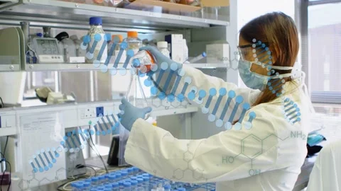 Lab tech reaching bottle pouring orange mix into flask prepping sample as DNA Stock Footage 333670694