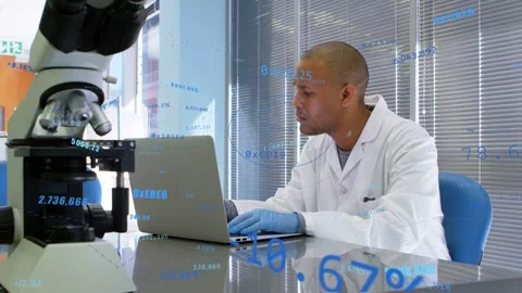 Lab tech typing laptop, causing blue numeric overlays floating and marking scope Stock Footage 334466350