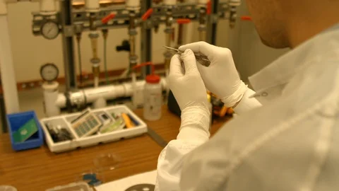 Lab tech using tweezers Stock Footage 106899697