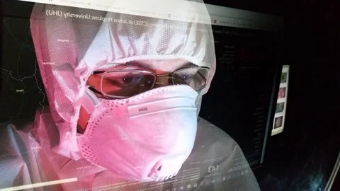 Lab Tech Watching the Map and the Picture of Coronavirus Stock Footage 126289108