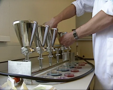 Lab technician changes a filter in water research - wide shot Stock Footage 126043259