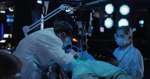 Lab technician does an autopsy on an alien. Scientists are experimenting on a Stock Footage 102980113