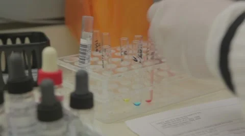 Lab technician drops solution in test tube Vídeos de archivo 59799116