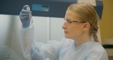 Lab Technician Examining Bacterial Sample in Test Tube Stock Footage 318595916