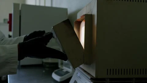 Lab Technician Extracts Porcelain Containers from Autoclave Stock Footage 346622853