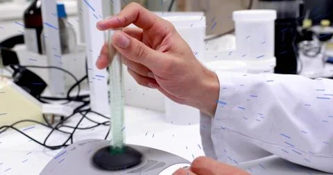 Lab technician hand, lab coat sleeve, inserting glass tube into mixer at lab Stock Photos