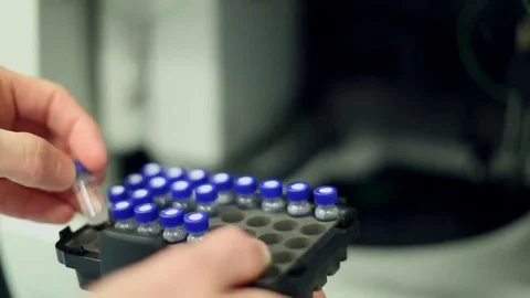 Lab Technician Handling Block of Vials Stock Footage 69087709