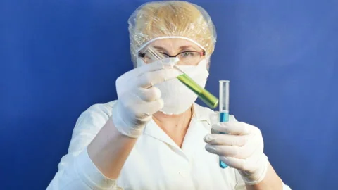Lab technician holding tubes test on blue background. Stock Footage 123163390
