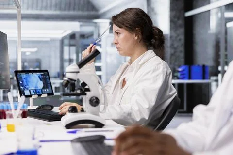 Lab technician looking at 3D molecular model visualization on computer Stock Photos