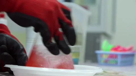 A lab technician mixes a pink liquid in the flask Stock Footage 64455391