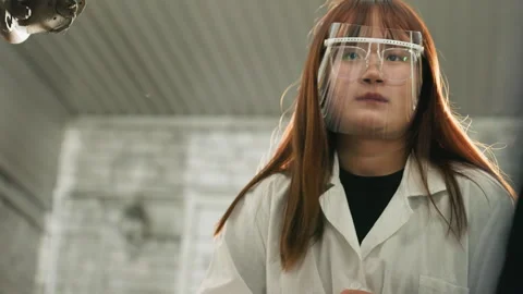 Lab Technician Observing Lifted Car and Taking Notes in Mechanical Workshop Stock Footage 304973317