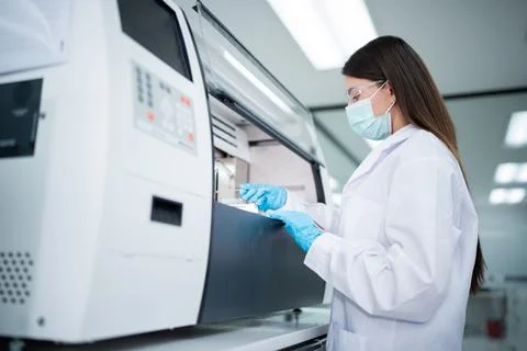 Lab technician operates a machine in a laboratory in the morning, conductin.. Stockfoto's