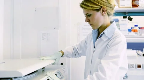 Lab Technician Placing Test Tube in Centrufuge Video stock 8663396