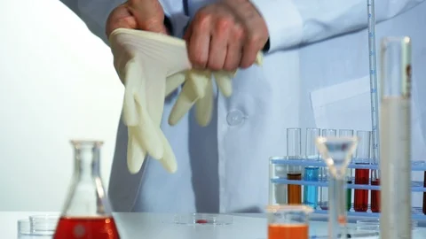 Lab technician puts on rubber gloves Stock Footage 88379689