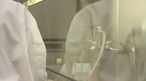 Lab technician puts sample into fridge unit Stock Footage 21935736