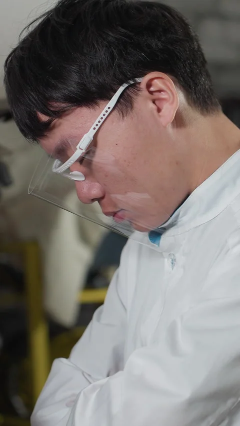 Lab Technician Reflects in Workshop Captured on Smartphone Stock Footage 318236628
