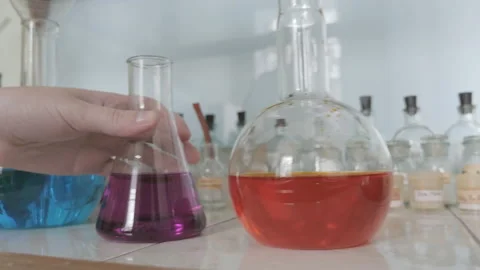 Lab technician, scientist taking flask with colorful liquid in the lab Stock Footage 86067572