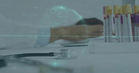 Lab technician scribbling notes at lab bench, with MONKEYPOX VIRUS vials and Stock Photos