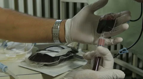 Lab technician taking blood sample in test tube, bag with blood, hands close up. Stock Footage 58613658