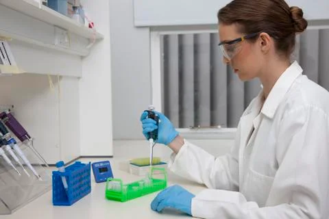 Lab technician using micro-pipette Stock Photos