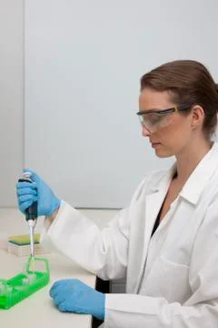 Lab technician using micro-pipette Stock Photos