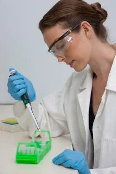 Lab technician using micro-pipette Stock Photos