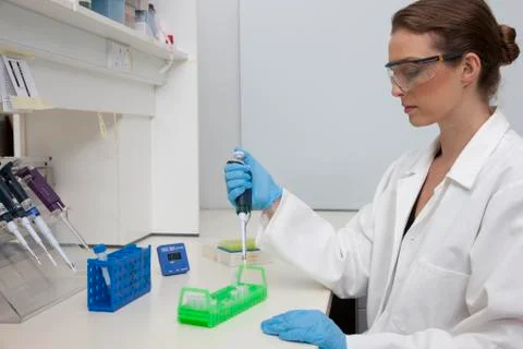 Lab technician using micro-pipette Stock Photos