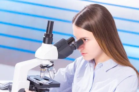 Lab technician using microscope Stock Photos