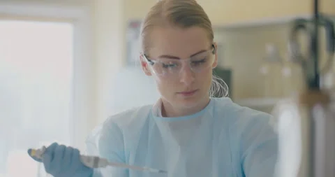 Lab Technician Using Pipette for Medical Test Stock Footage 318597006