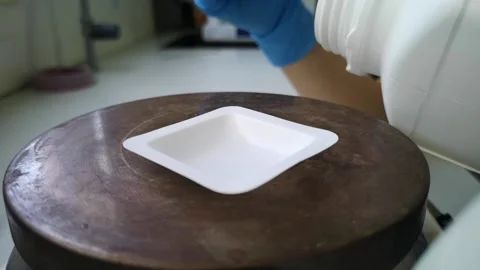Lab technician using an scale to weight powdered test sample. Researcher and Stock Footage 134287891