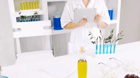 Lab technician using tablet computer in nutrition experiment Stockbeeldmateriaal 199630121