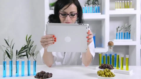 Lab technician using tablet computer in nutrition experiment Stock Footage 199630141