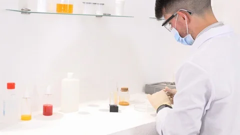 Lab technician working in a laboratory and researching new medicines Video stock 117933729