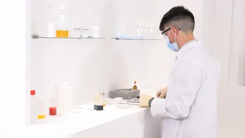 Lab technician working in a laboratory and researching new medicines Stock Footage 117934811