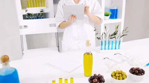 Lab technician working on tablet computer for food nutrition experiment Stock Footage 199630182