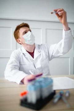 Lab technician writes down the received tests for transfer to the doctor Stock Photos