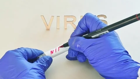 A lab technician writes the name of the NIPAH virus on a blood test tube. Stock Footage 327822391