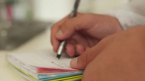Lab technician writing on a notebook with pen slow motion Stock Footage 79774072