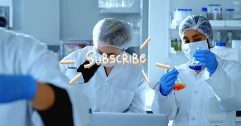 Lab techs in coats inspecting samples at microscope and pipetting blue and Stock Photos