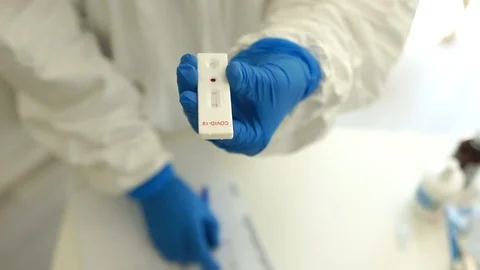 Lab test cassette tested NEGATIVE for viral novel coronavirus SARS-CoV-2 virus Stock Footage 129075187