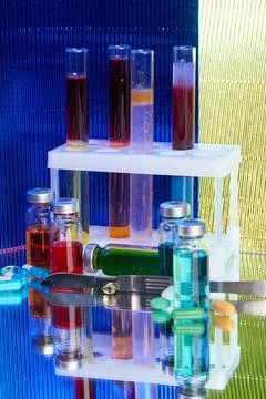 Lab test tubes and bottles with colored substance. Stock Photos