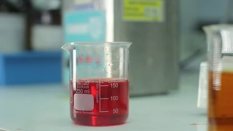 Lab worke stirring liquid Stock Footage 77046211