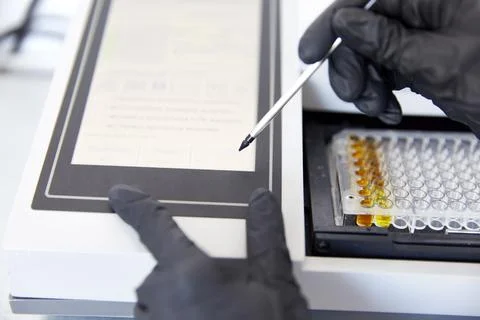 Lab Worker Adding and analyzing Liquid to Test Tubes Stock Photos