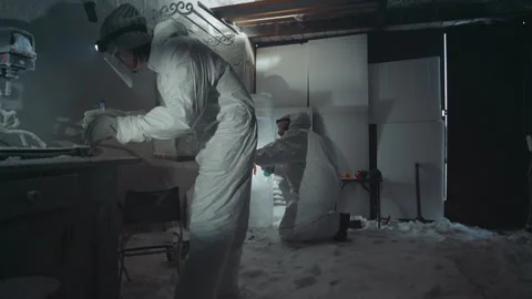 Lab worker analyzes icy specimen carefully. Research professional in protective Video stock 342747787