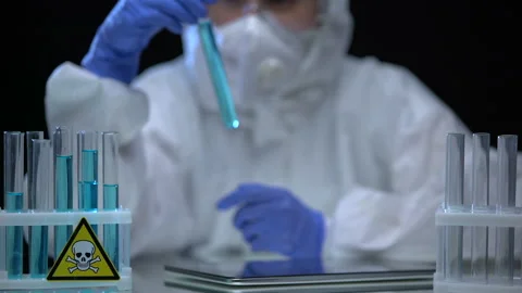 Lab worker inspecting test tubes with poison for sediments, dissolution process Stock Footage 115413182