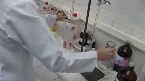Lab Worker Mixes Pours Alcohol Into A Carafe Video stock 18970276