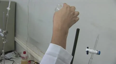 Lab Worker Pouring a Liquid Into A Very Long Test Tube Video stock 18966596